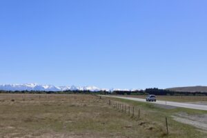 Burkes Passを過ぎると出てくる長い直線の道路と前方に高い山並み（サザンアルプス）